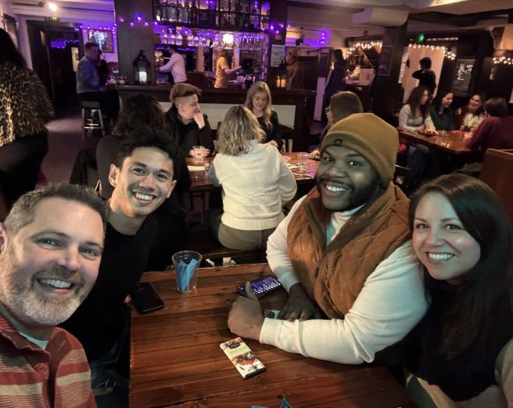 Members pose together during trivia