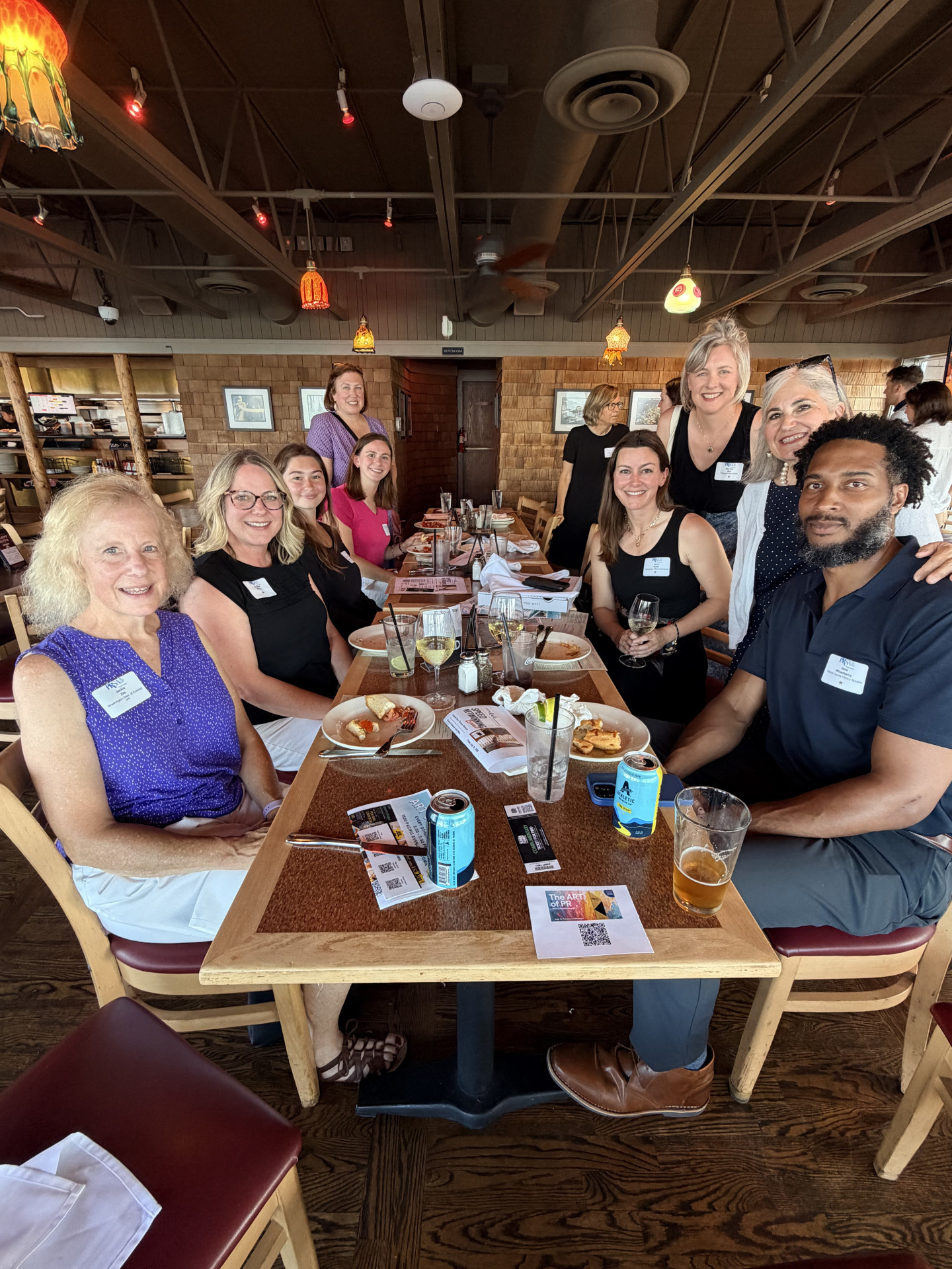 A group of PRSA Puget Sound Members sitting at a table at a networking event.